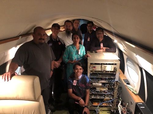 Group photo of 8 people inside the cabin of the Gulfstream-III jet